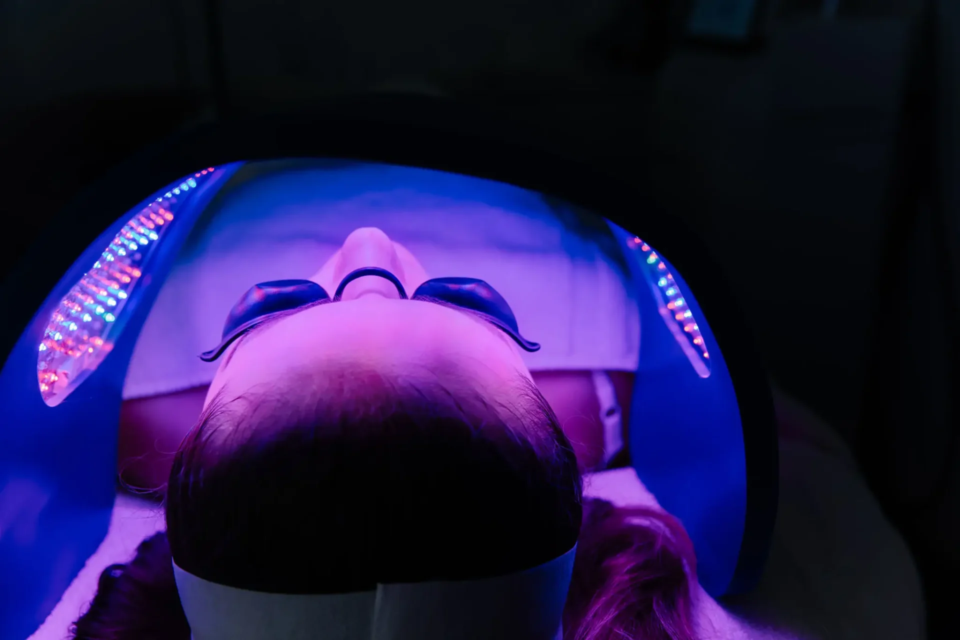 Person undergoing LED facial light therapy