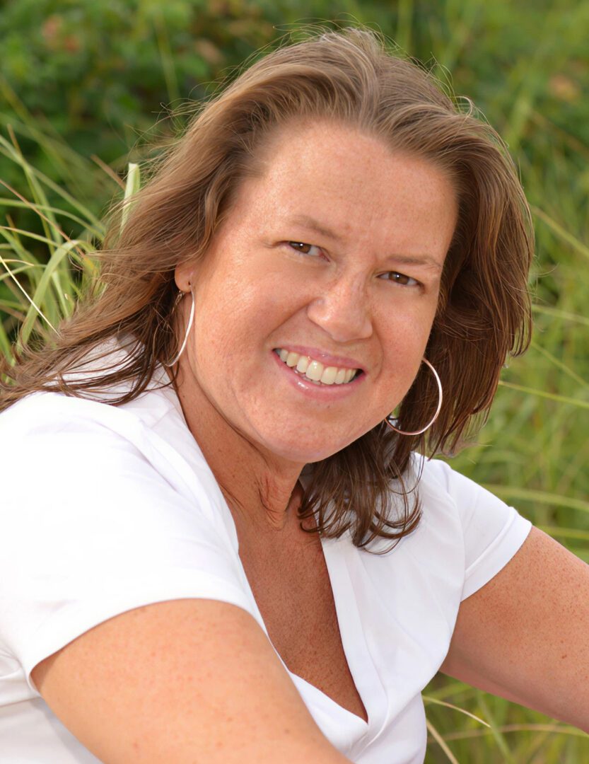 Smiling woman outdoors in white top